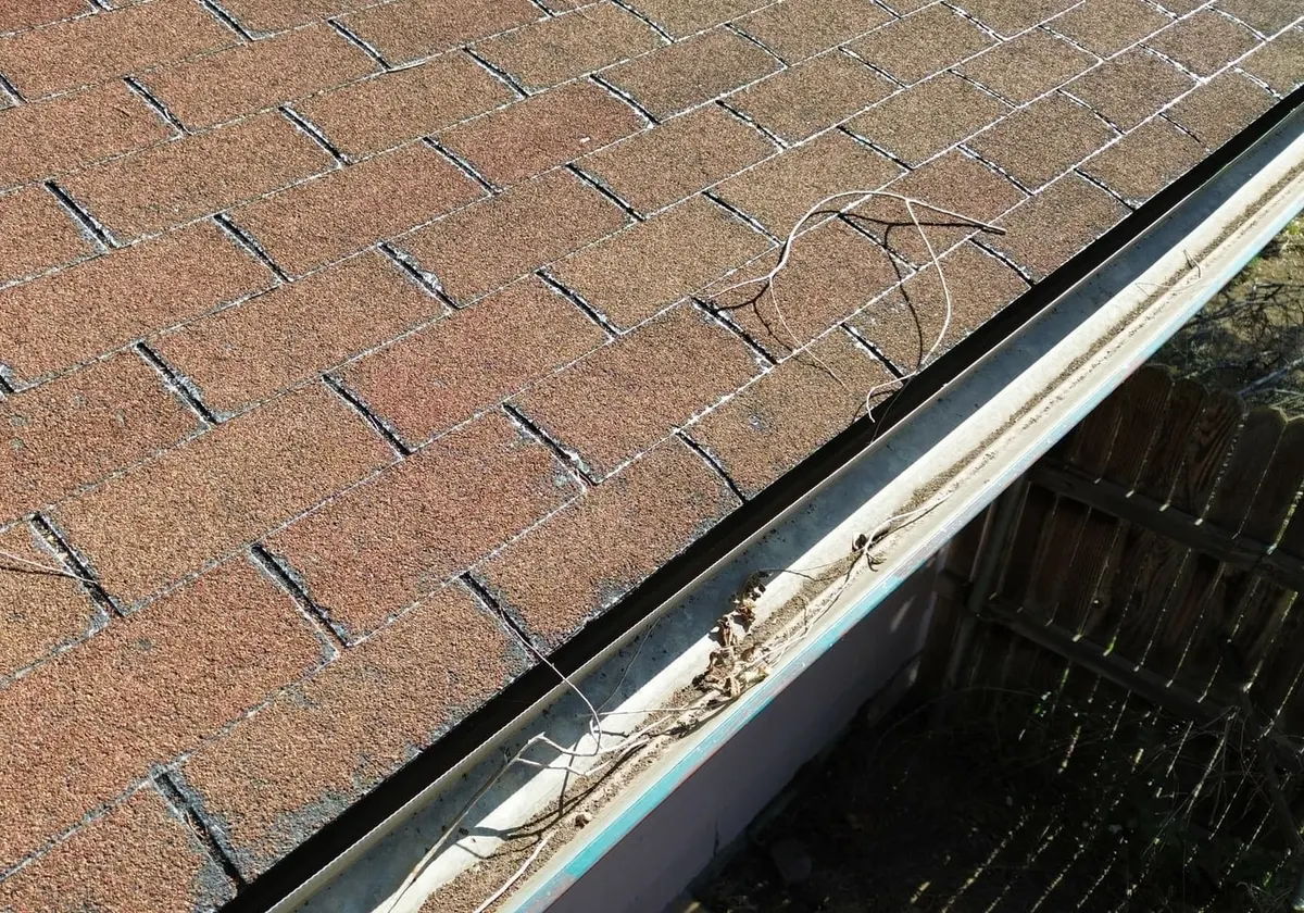 Close view of the worn shingle surface before the tear-off